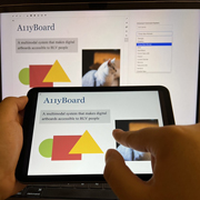 A user demonstrates the A11yBoard touchscreen interface.