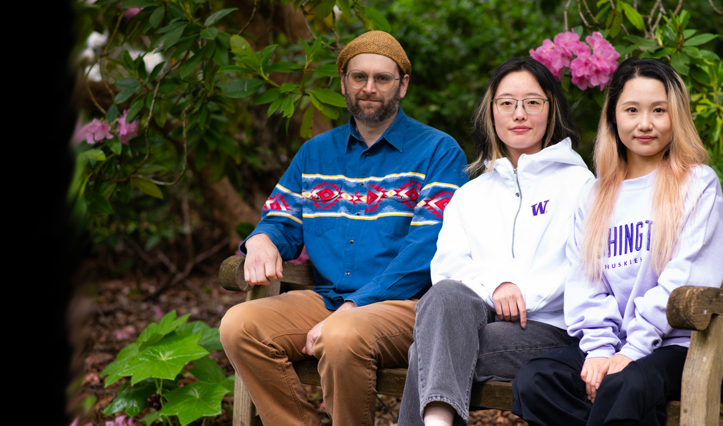 Zach Greenman, Skye Shen and Kexuan Feng seated on a bench.