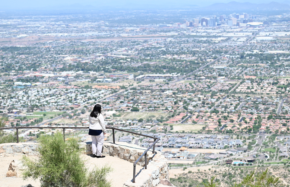 Bishop looks over southern Phoenix from a viewpoint at South Mountain Park. South Mountain has a prominent role in oral traditions and songs of the Akimel O’odham (Pima) and other tribes in the region.