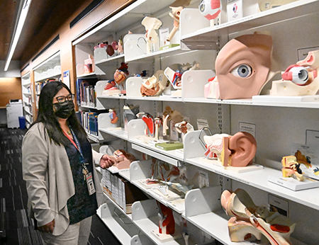 Bishop scans items on display in the University of Arizona’s Health Sciences Library.