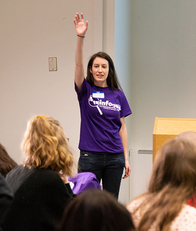 Liz Crouse, with her hand raised, speaks with students during MisinfoDay 2019 on the UW campus.
