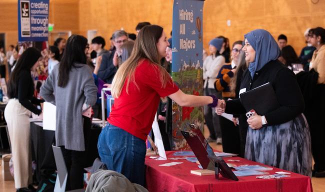 A woman shakes hands with a company representative