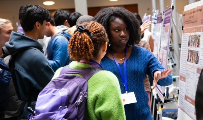 Ndeye Diop shows her poster to a visitor