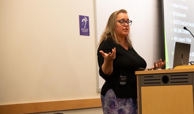 Cynthia Leitich Smith speaks at a lectern.