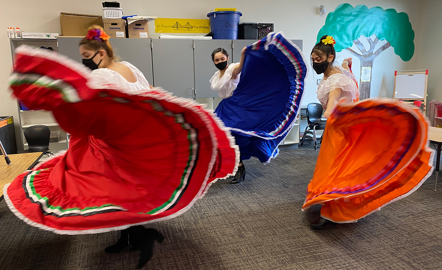 Dancers in traditional garb perform a Mexican folk dance.