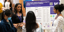 Pournami Varma (left) presents a poster on “Using Family Health Informatics to Improve Asthma.”