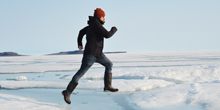 Jason Young leaps across ice.