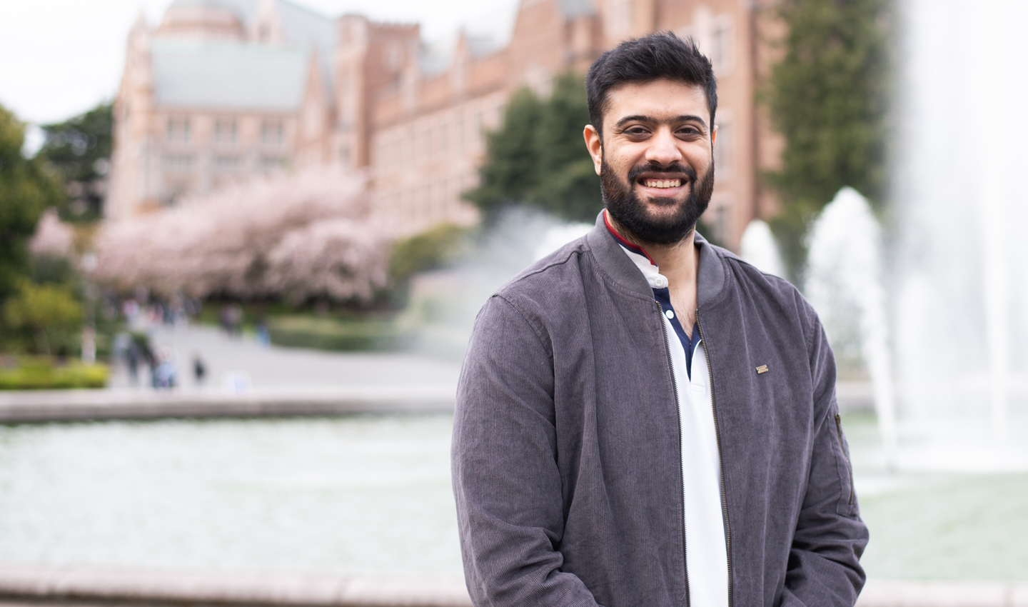 Nikhil Shenoy pictured in front of Drumheller Fountain and Mary Gates Hall on the UW campus.