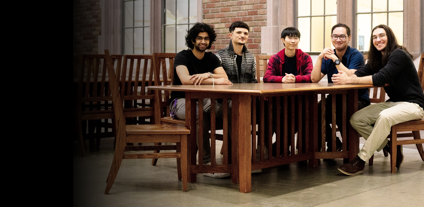 5 students seated around a table