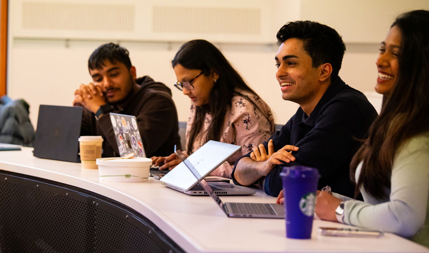 Students smile during a class on generative artificial intelligence