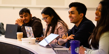 Students smile during a class on generative artificial intelligence