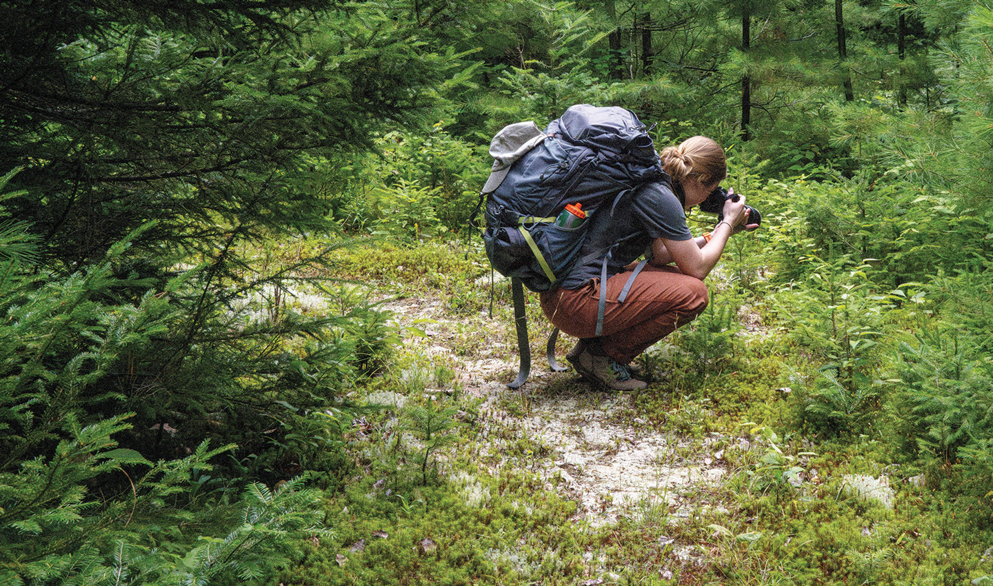 Anne Longman takes a photo while backpacking.