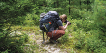 Anne Longman takes a photo while backpacking.