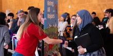 A woman shakes hands with a company representative