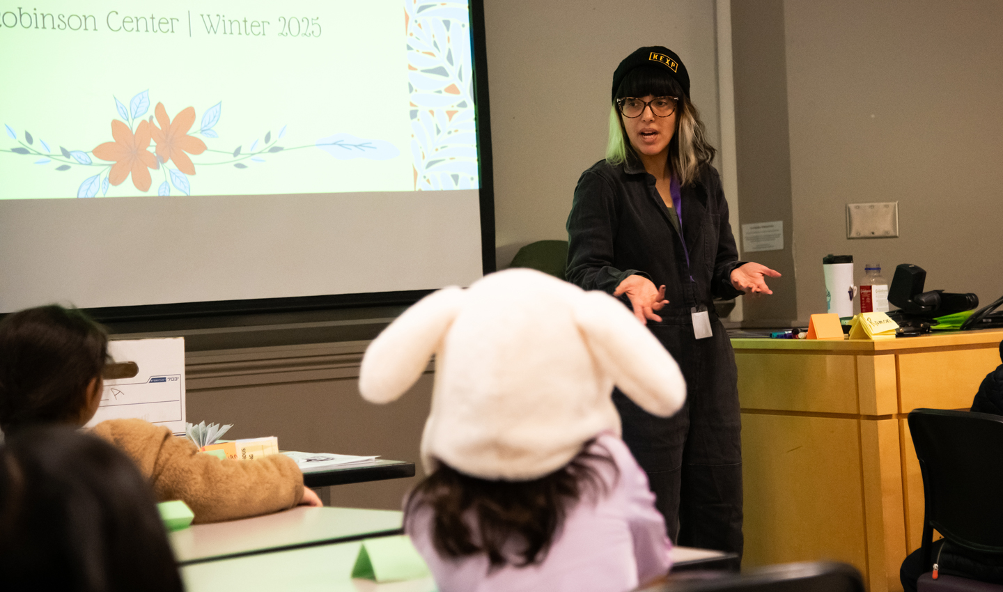 Itza Carbajal speaks before a group of children