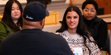 A woman speaks in a group setting