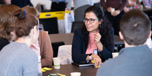 Tanu Mitra speaks with students while seated
