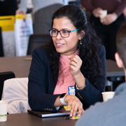 Tanu Mitra speaks while seated
