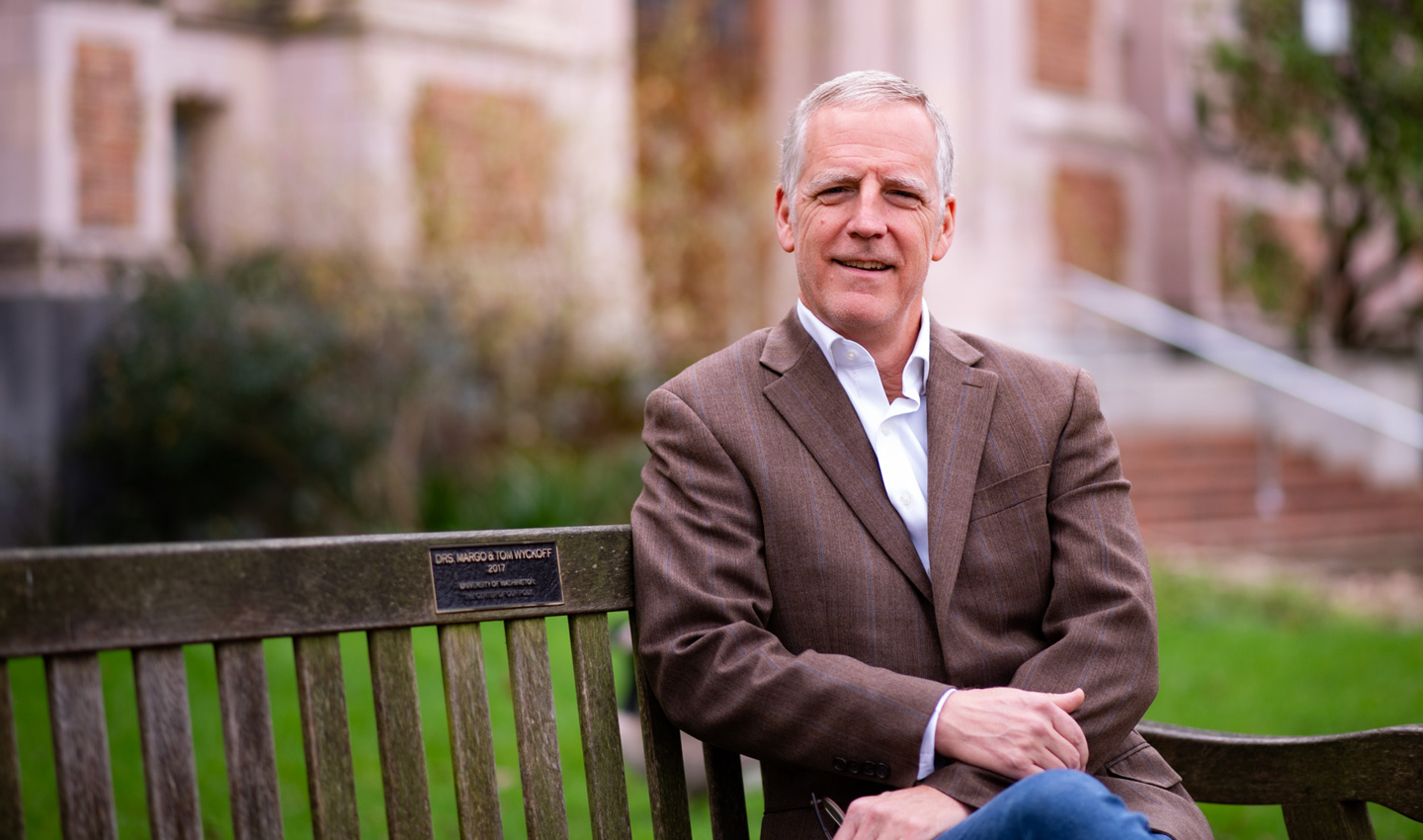 Adam Moore, seated on a bench.