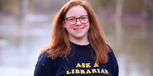 Jennifer Sheffield wearing a sweatshirt with the words "Ask a Librarian."