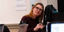 Heather Whiteman leans while listening in a classroom