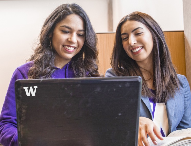 2 students with a UW laptop