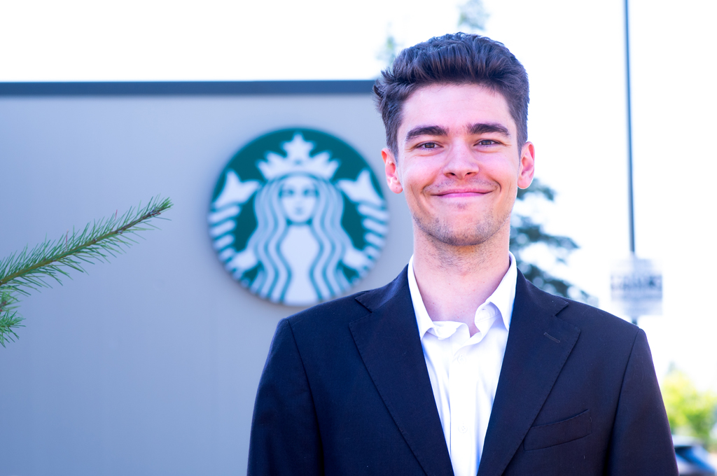 Connor Klentschy in front of a Starbucks.
