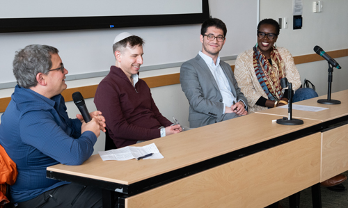 Panelists answer question at the symposium