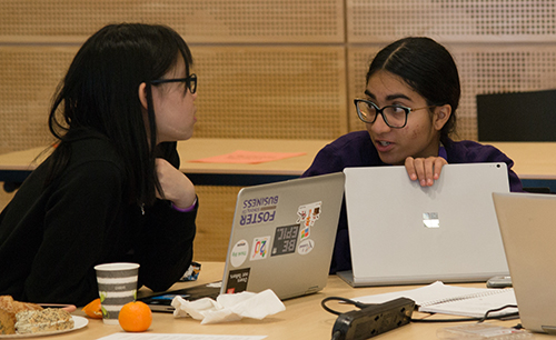 Linh Tran and Harkiran Saluja confer during the Hackathon.