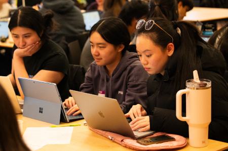 3 students working on laptops