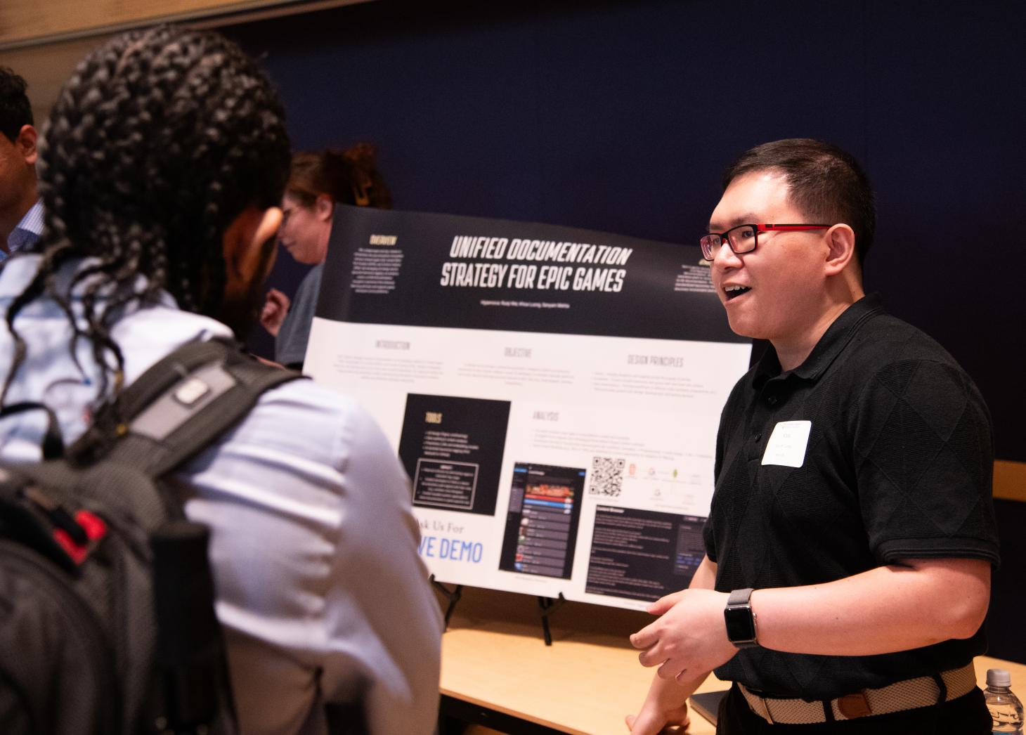 Student presents project to event attendee