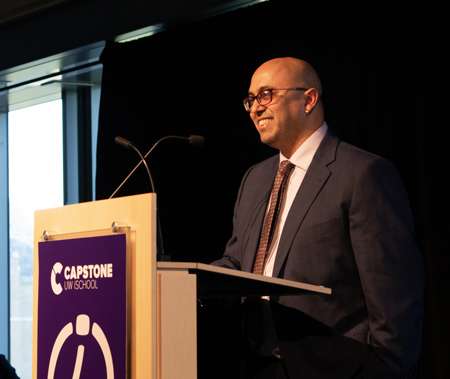 Anind Dey looks out from behind a lectern.
