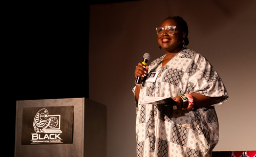 Tracie D. Hall speaks on stage.