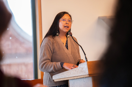 Miranda Belarde-Lewis speaks at a lectern.