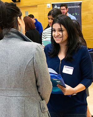 A student speaks with an employer at the 2019 iSchool Career Fair.