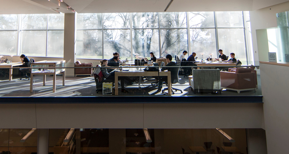 People work at tables in the Gallagher Law Library.