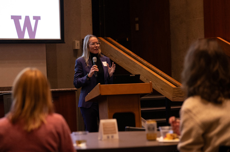 Kris Tomasovic Nelson speaks at a lectern.