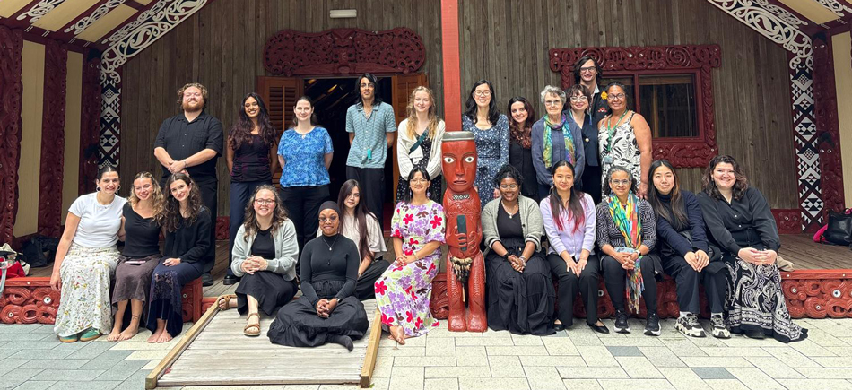 A group of 23 people poses for a group photo.