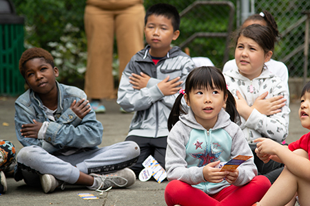 Kids listen to a story during a 2019 Read-a-Rama camp in Seattle.