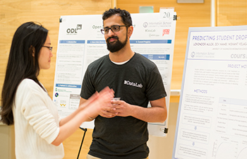 Ph.D. students An Yan and Lovenoor Aulck discuss their research.