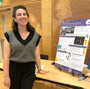 Rotem Landesman stands with her project poster.