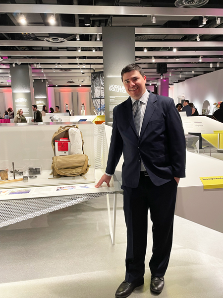 Mike Teodorescu stands next to a SurgiBox kit at the MIT Museum.