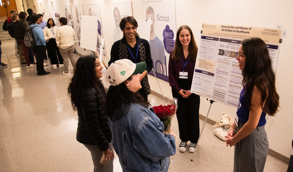 Five people hold a discussion around a research poster.