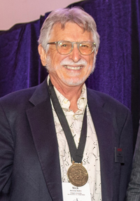Nicholas Belkin wears a medal at a ceremony