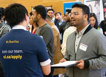 A student speaks with an employer at the 2019 iSchool Career Fair.