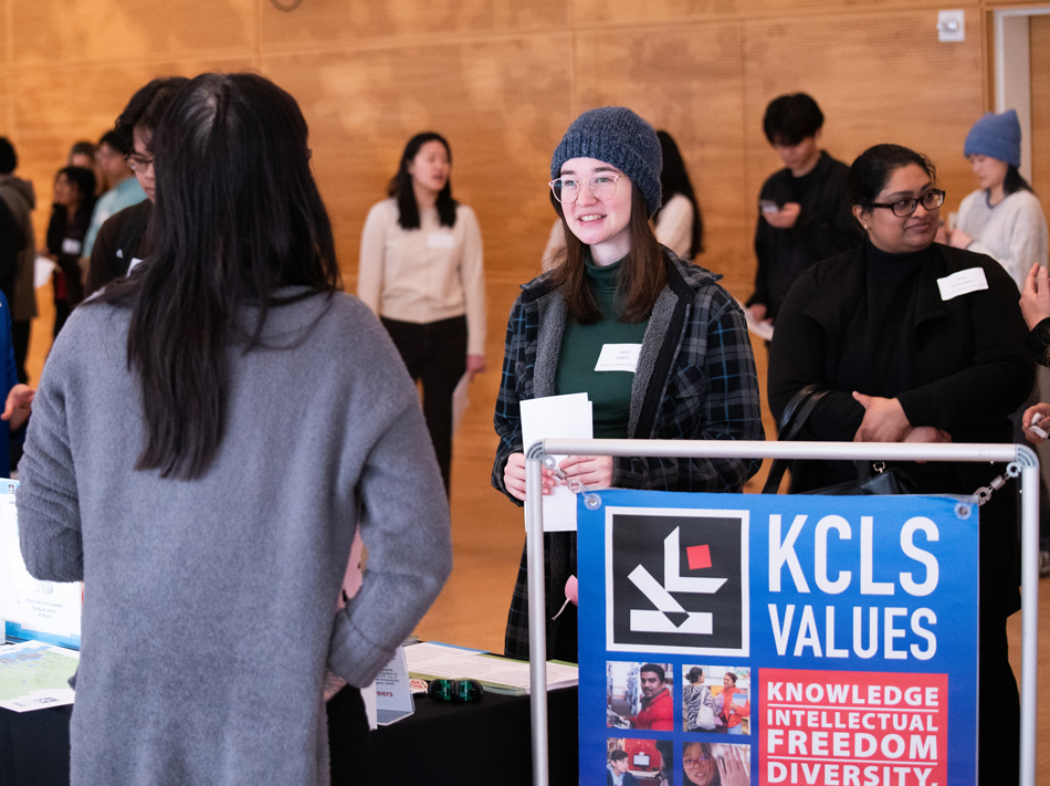 A woman speaks to a representative of King County Library System.