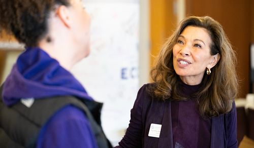 Cynthia del Rosario speaks to a student at the Hack for Social Good.