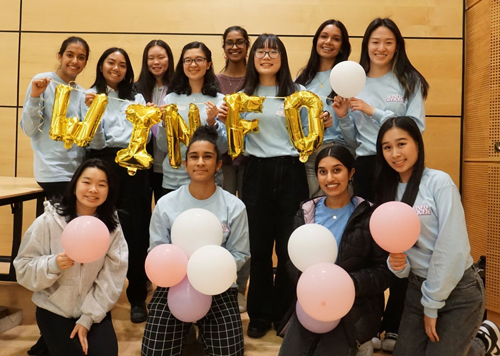 Students pose with balloons