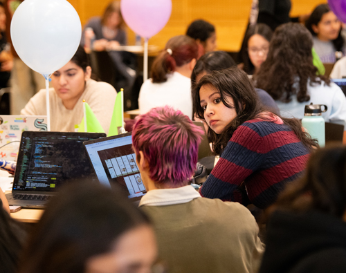A woman speaks with a mentor.