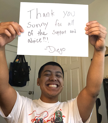 Informatics student Diego Torres holds a sign thanking his mentor.